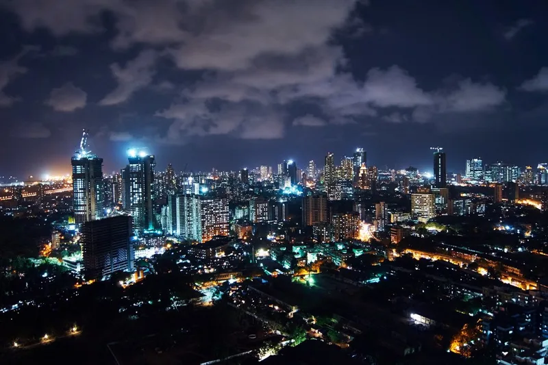 高層ビルの明かりが並ぶ夜の都市の写真