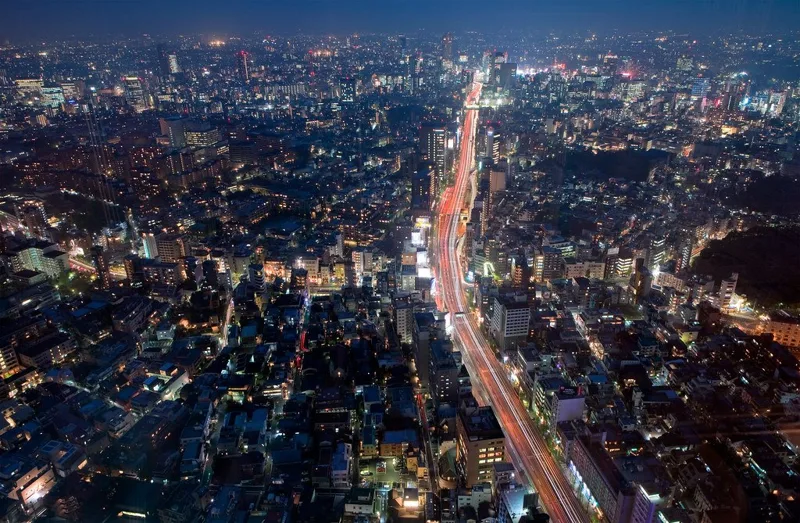 夜の東京の街を貫く高速道路の光の写真